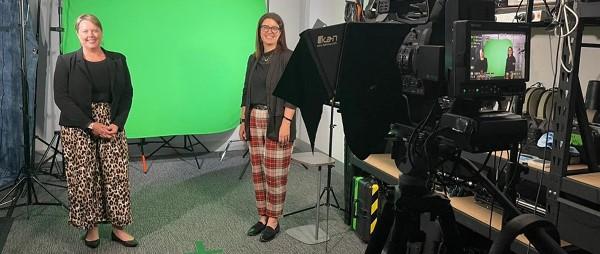 Rachael McMahon and Connie Galati standing in front of a screen recording content.