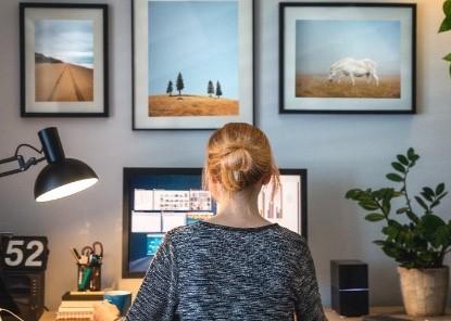 Image of a woman sitting in front of a laptop at home