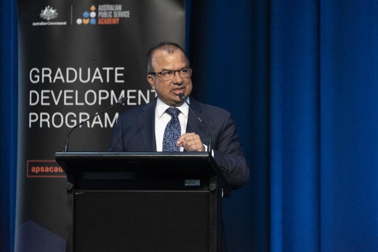 Dr Subho Banerjee speaks at a lectern during the event.