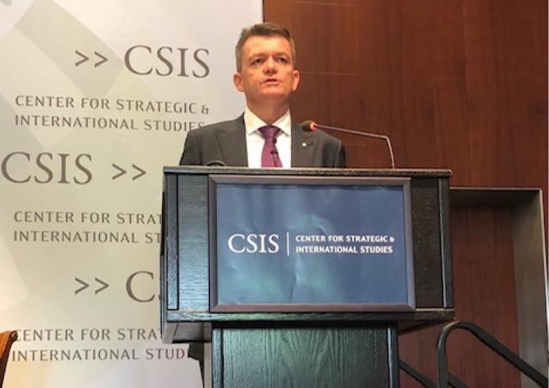Andrew Colvin, Integrity Faculty, stands at a lectern delivering a speech.