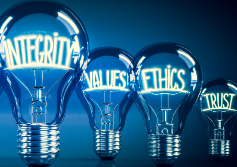 4 light bulbs of different sizes. The biggest has the word integrity inside. The others say values, ethics and trust.