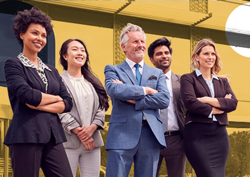 Five people standing. Three have their arms crossed.