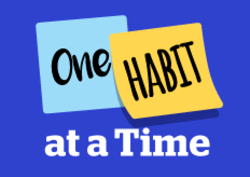 A blue background with two Post it Notes, one note says "One" the second note says "Habit" and wording underneath says "at a Time" 