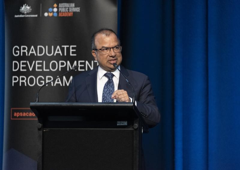 Dr Subho Banerjee speaks at a lectern during the event.