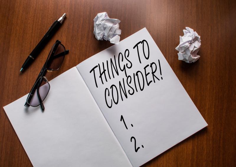 Conceptual handwriting showing Things To Consider. Concept meaning think about something carefully in order to make decision Notebook small wrinkled paper balls reading glasses wooden table