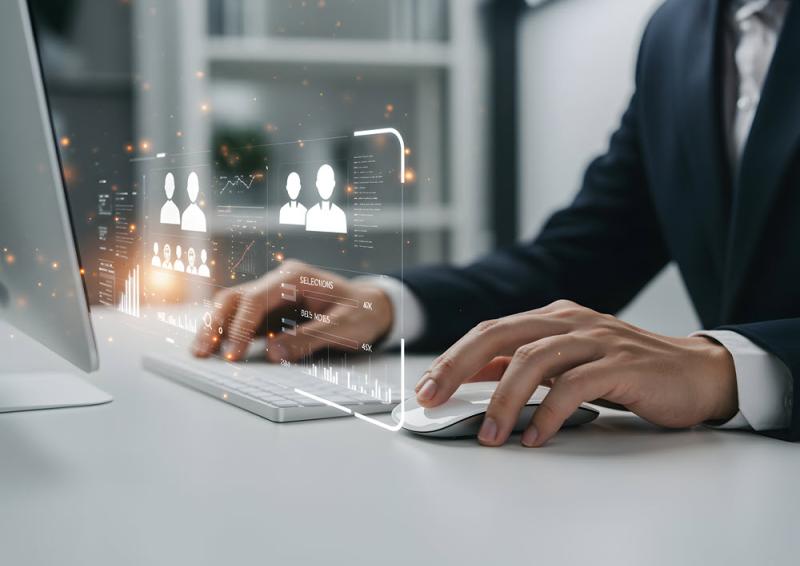 Business Professional Using Computer with Futuristic Interface for Data Analysis and Recruitment