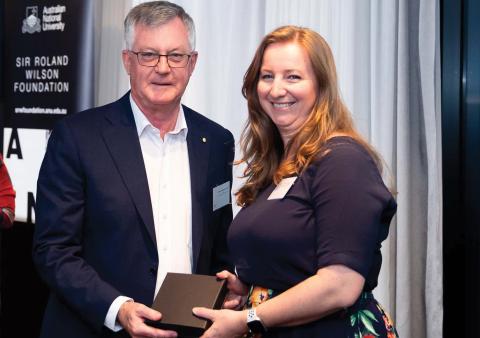 Dr Helen Benassi receiving an award from Dr Martin Parkinson AC PSM.