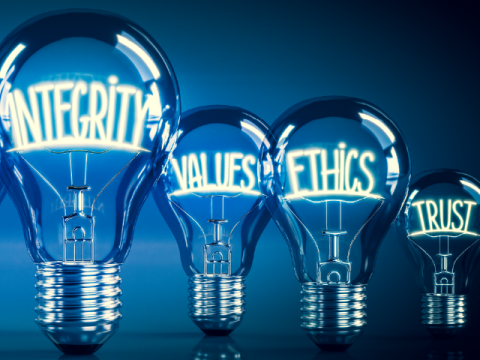 4 light bulbs of different sizes. The biggest has the word integrity inside. The others say values, ethics and trust.