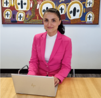 Portrait of Adina Leu working at a laptop computer.