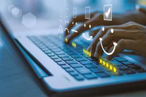 Hands typing on a keyboard.