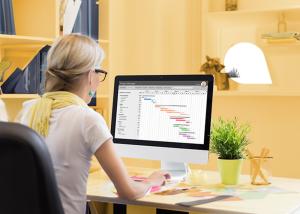 Person sitting at a desk with a graph on the screen