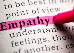 An illustrative picture of a pink highlighter pen being used on the word ‘empathy’ in a sentence of text.