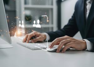 Business Professional Using Computer with Futuristic Interface for Data Analysis and Recruitment