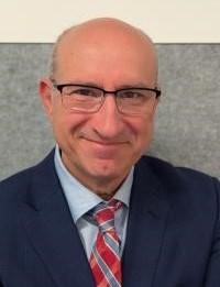 Headshot of Antonio Di Dio in a suit and tie. 