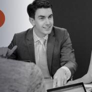 Stock image of two people have a discussion at a table.