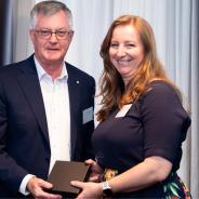 Dr Helen Benassi receiving an award from Dr Martin Parkinson.