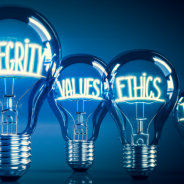 4 light bulbs of different sizes. The biggest has the word integrity inside. The others say values, ethics and trust.