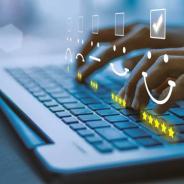 Hands typing on a keyboard.