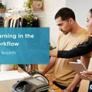 Illustrative photo image of a woman and a man in a retail clothes shop with the woman giving instructions to the man on how to undertake a task.