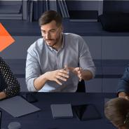 Group of people sitting around a table discussing a topic