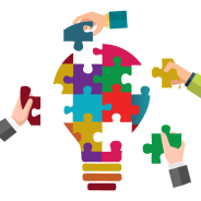 Light bulb jigsaw with hands placing pieces