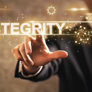 An illustrative image of a person pressing an ‘integrity’ word on a digital screen.