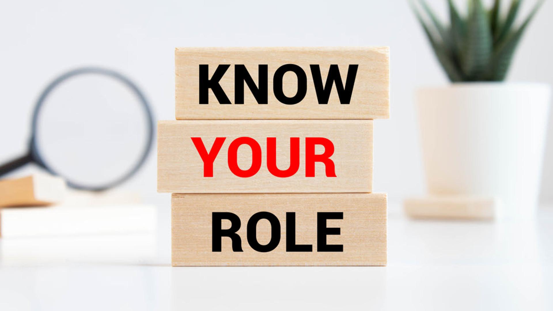 KNOW YOUR ROLE text on a wooden cubes on a white background
