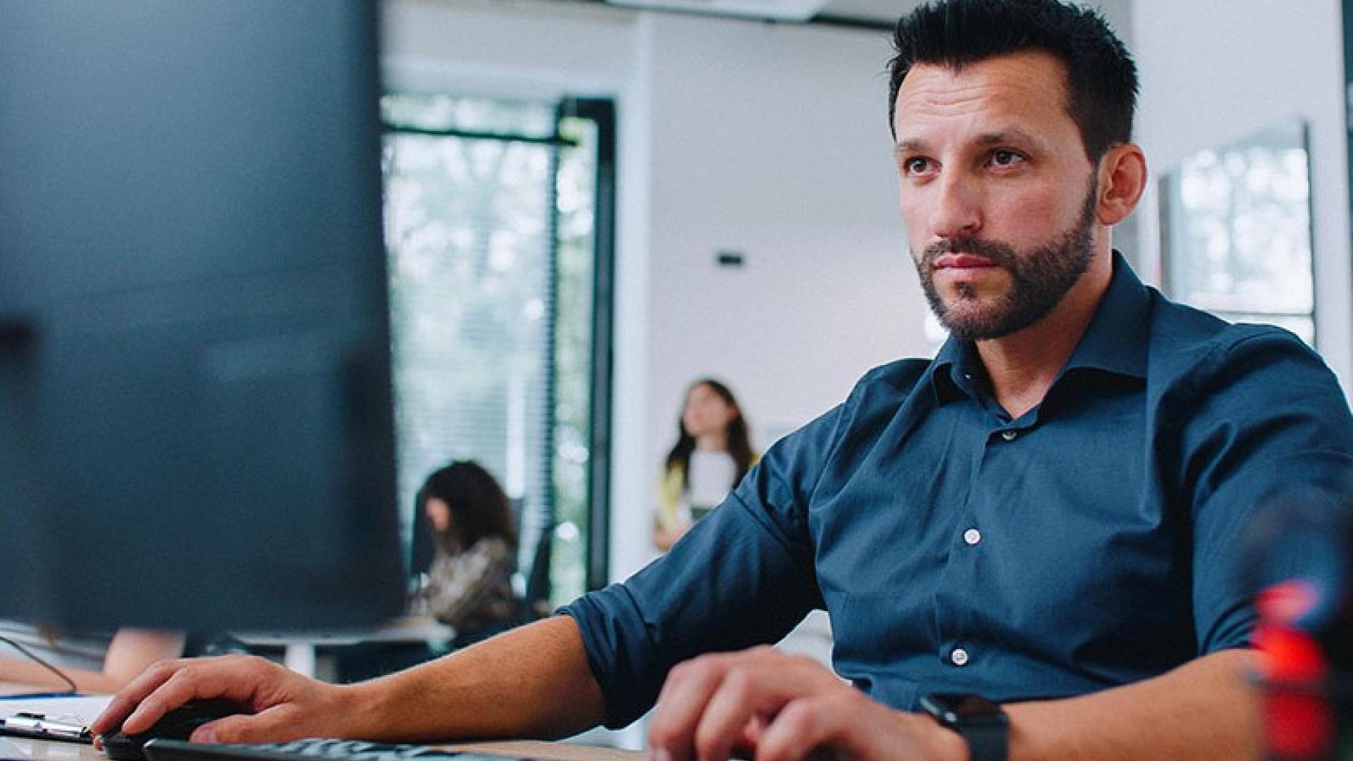 Person sitting at a desk working on a laptop