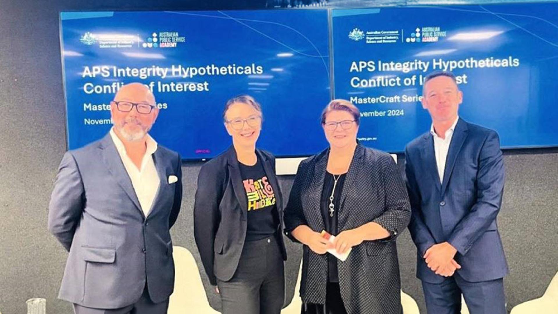 Photo of three APS Senior Executive Service and the Facilitator in a room as part of a panel ‘hypothetical’ discussion. 