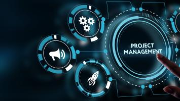 An image of  a screen with a person’s finger pressing a large button saying ‘Project Management’ 