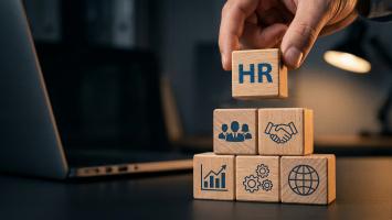 Human resources management concept with hand placing HR text block on top of business strategy pyramid structure