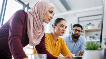 An image of 3 people Diverse Business Team members Working Together on Computer in Modern Office
