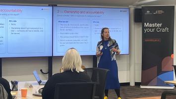 An image of Professor Beth Noveck in lecture theatre teaching participants.