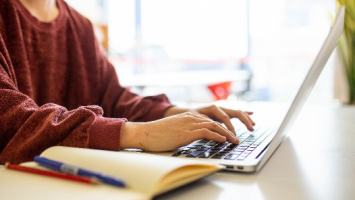 Woman typing on a laptop