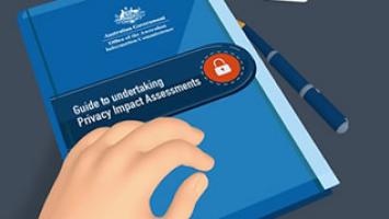 Illustration of a blue government booklet titled “Guide to Understanding Privacy Impact Assessments” with an orange padlock icon on the cover. A hand rests on the booklet, and a blue pen lies beside it on a dark surface. The cover also displays the Australian Government crest and the text “Office of the Australian Information Commissioner.”