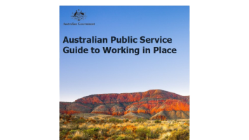 Cover of the Australian Government publication Australian Public Service Guide to Working in Place. The cover features the Australian Government crest at the top, the title in large black text on a blue gradient background, and a landscape photograph of a red rocky mountain range with native vegetation in the foreground. The design combines government branding with an Australian outback scene.