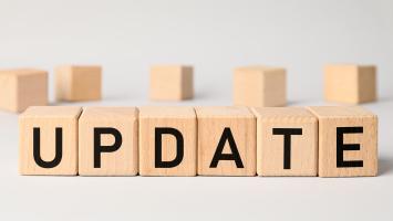 Wooden cubes with word UPDATE on light background