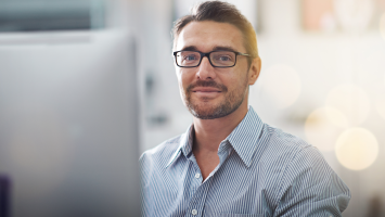 Man sitting in front of a computer screen